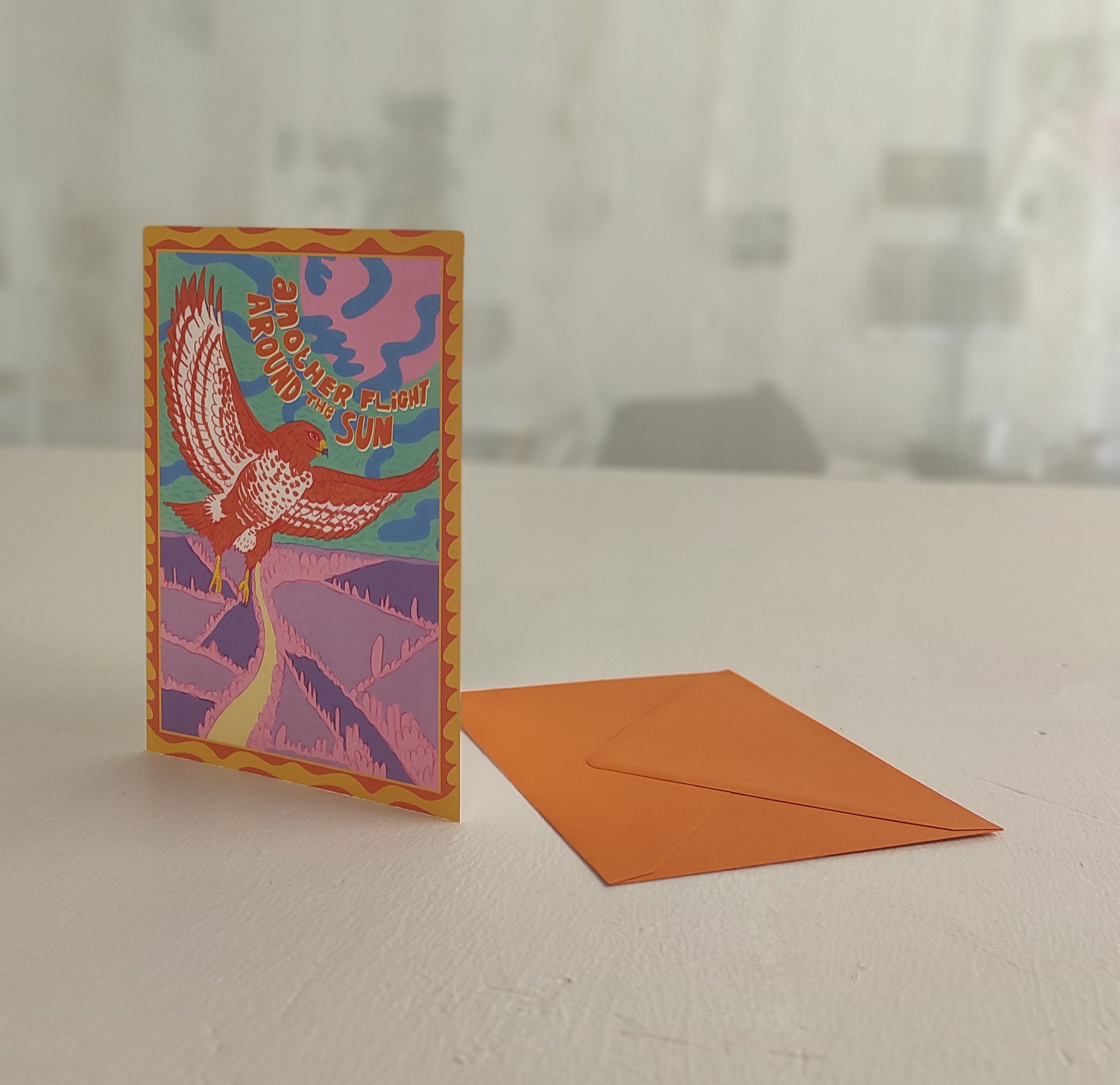 Colorful card with a bird design on a white surface