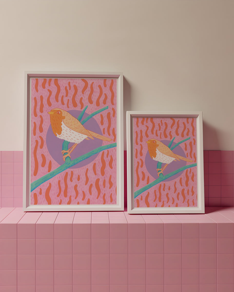 Two framed artworks of birds on a pink and beige tiled wall.