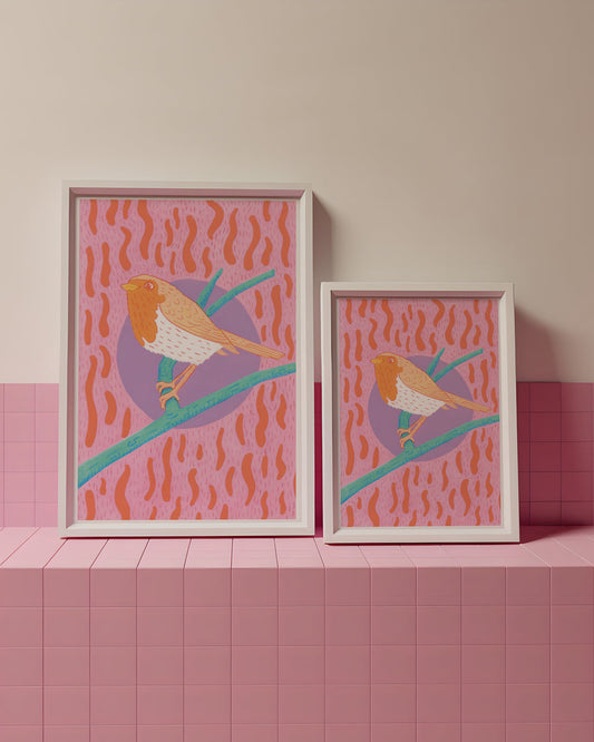 Two framed artworks of birds on a pink and beige tiled wall.