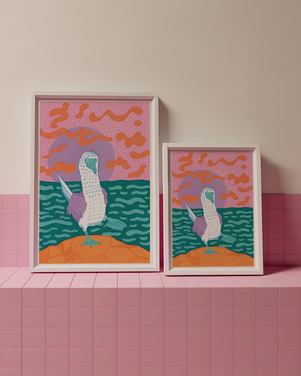 Two framed artworks of a bird on a pink and orange background with a pink wall and shelf.